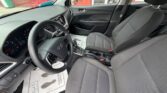 Gray front interior of a Hyundai with the steering wheel, driver and passenger seats, center console, and dashboard.
