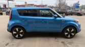 Blue compact crossover SUV shown in a side profile parked in a parking lot, featuring black alloy wheels and dark-tinted rear windows.