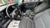 Interior of a dark gray SUV: front seats, steering wheel, center console, and automatic gear shifter visible from the driver’s side.