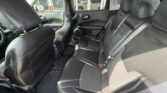 Black leather SUV interior with a three-seat rear bench and visible front seats, viewed from the rear passenger side.