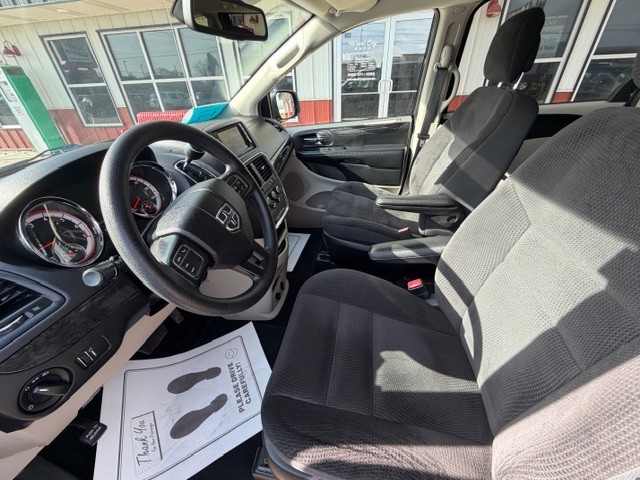 Interior of a pickup truck from the driver's seat, showing steering wheel, dashboard, center console, and two front seats.