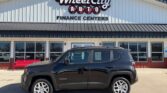 Black Jeep Renegade SUV parked in front of Wheel City Auto Finance Centers storefront.