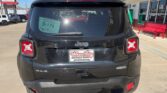 Rear view of a black Jeep 4x4 SUV at a dealership, with a Wheel City license plate frame and a D-179 window sticker.