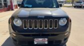 Front view of a dark gray Jeep SUV parked in a dealership lot, showing the seven-slot grille and round headlights; dealer plate reads Wheel City Auto Finance Centers.
