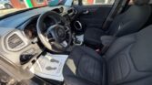Interior of a dark gray Jeep: front driver and passenger seats, steering wheel, center console with gear shifter, and dashboard viewed from the open driver's side door.