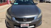 Front view of a gray Honda sedan parked in a dealership lot, with a Wheel City Auto Finance plate frame visible on the bumper.