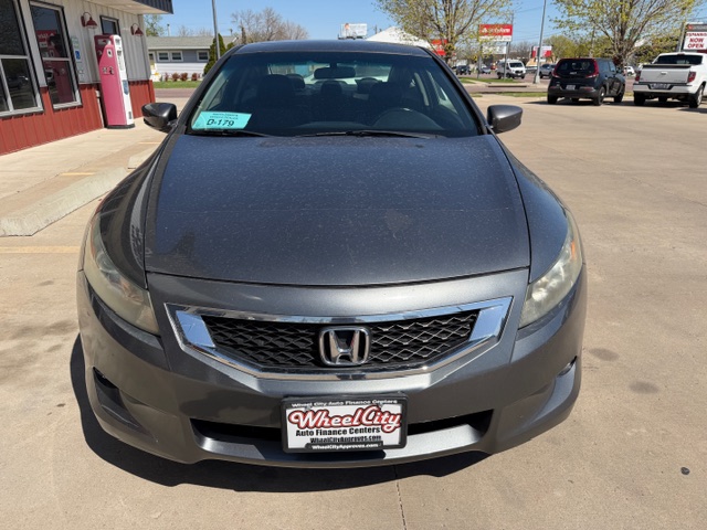 Front view of a gray Honda sedan parked in a dealership lot, with a Wheel City Auto Finance plate frame visible on the bumper.