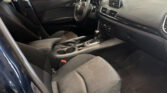 Interior of a Mazda car with black seats, steering wheel, center console, and dashboard visible.