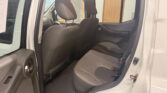 Open rear passenger door showing grey fabric back seat and headrests in a white SUV interior.