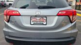 Rear view of a silver Honda SUV in a car lot, showing taillights, rear wiper, and Wheel City license plate frame on the bumper.