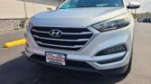 Front three-quarter view of a white Hyundai SUV in a parking lot, dealership plate visible reading Wheel City Auto Finance Centers