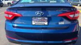 Blue Hyundai Sonata rear view in a car dealership lot with a Wheel City dealer plate visible on the bumper.