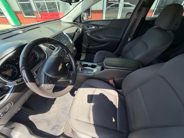 Front interior of a Chevrolet SUV showing the steering wheel, dashboard, and center console from the driver's seat perspective.