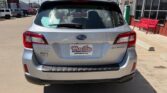 Silver Subaru Outback viewed from the rear in a dealership lot, with Wheel City license plate frame on the back.