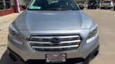 Front view of a silver Subaru SUV in a dealership lot, chrome grille with the Subaru emblem and a Wheel City license plate