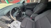 Interior of a Hyundai sedan: driver and front passenger seats, dashboard, steering wheel, and center console visible.