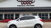 White SUV parked in front of Wheel City Auto Finance Centers dealership building