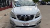 Front view of a white Buick SUV parked in a dealership lot with Wheel City license plate frame in foreground.