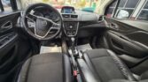 Black leather car interior featuring the steering wheel, center console, and infotainment screen viewed from the front seats. (Informative)