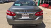 Rear view of a gray Nissan Altima SV in a dealership lot, showing the Wheel City plate frame.