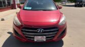 Front view of a red Hyundai car parked in a dealership lot, WheelCity license plate frame visible