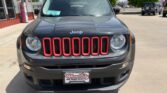 Front view of a dark gray Jeep SUV with red accented grille, parked in a lot outside a storefront; dealer plate reads Wheel City Auto Finance Centers.