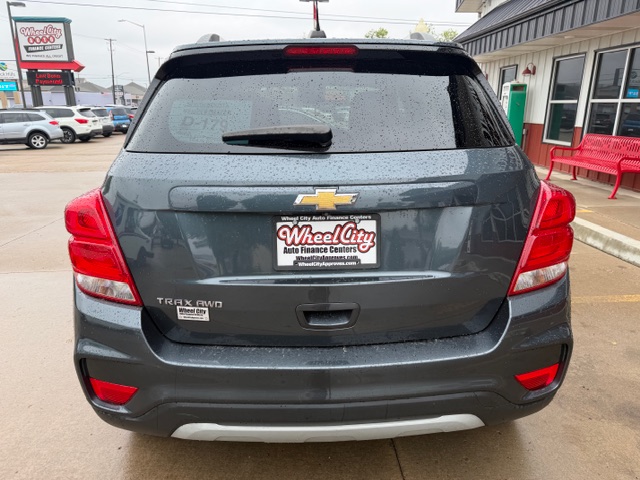 Gray Chevrolet Trax AWD, rear view, parked at a dealership with Wheel City Auto Finance Centers license plate frame visible.