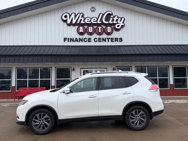 White SUV parked in front of Wheel City Auto Finance Centers storefront, dealership signage visible.