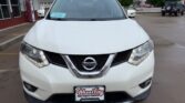 Front view of a white Nissan SUV parked in a dealership lot, with a Wheels City license plate frame on the front bumper.