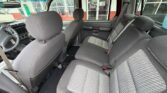 Interior view of a gray pickup truck cabin with front seats and a back bench