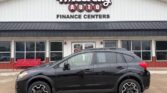 Black compact crossover SUV parked in front of Wheel City Auto Finance Centers storefront.