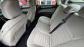 Light gray fabric rear seats in a sedan with three seating positions and headrests.