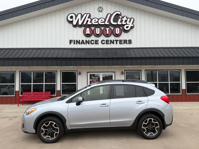 Silver SUV parked in front of Wheel City Auto Finance Centers storefront.