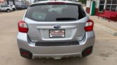 Rear view of a silver Subaru Forester in a dealership lot with a Wheel City license plate frame on the bumper area of the tailgate.