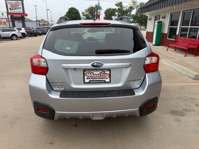 Rear view of a silver Subaru Forester in a dealership lot with a Wheel City license plate frame on the bumper area of the tailgate.