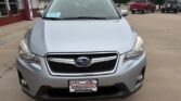 Front view of a silver Subaru SUV parked at a dealership, showing the grille, headlights, and Wheel City Auto Finance Centers license plate frame on the bumper.