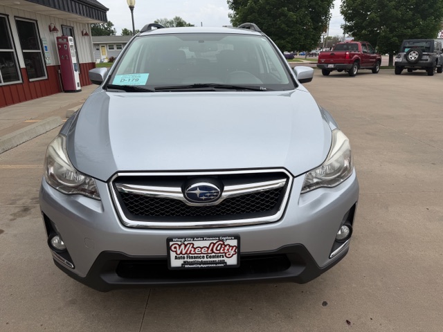 Front view of a silver Subaru SUV parked at a dealership, showing the grille, headlights, and Wheel City Auto Finance Centers license plate frame on the bumper.