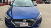Front view of a blue Hyundai sedan parked in a dealership lot, with Wheel City Auto Finance Centers license plate frame on the front bumper.