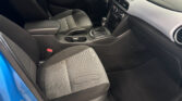 Front interior of a car with fabric seats, center console, gear shifter, and dashboard touchscreen.