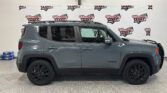 Gray SUV in a showroom with a Wheel City Auto banner backdrop, roof rails visible on top, and black wheels in the foreground.