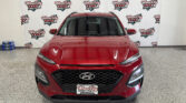 Front view of a red SUV inside a showroom, with a 'Wheel City Auto Finance Centers' backdrop.
