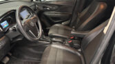 Car interior focusing on the front seats, steering wheel, and center console with black leather upholstery.