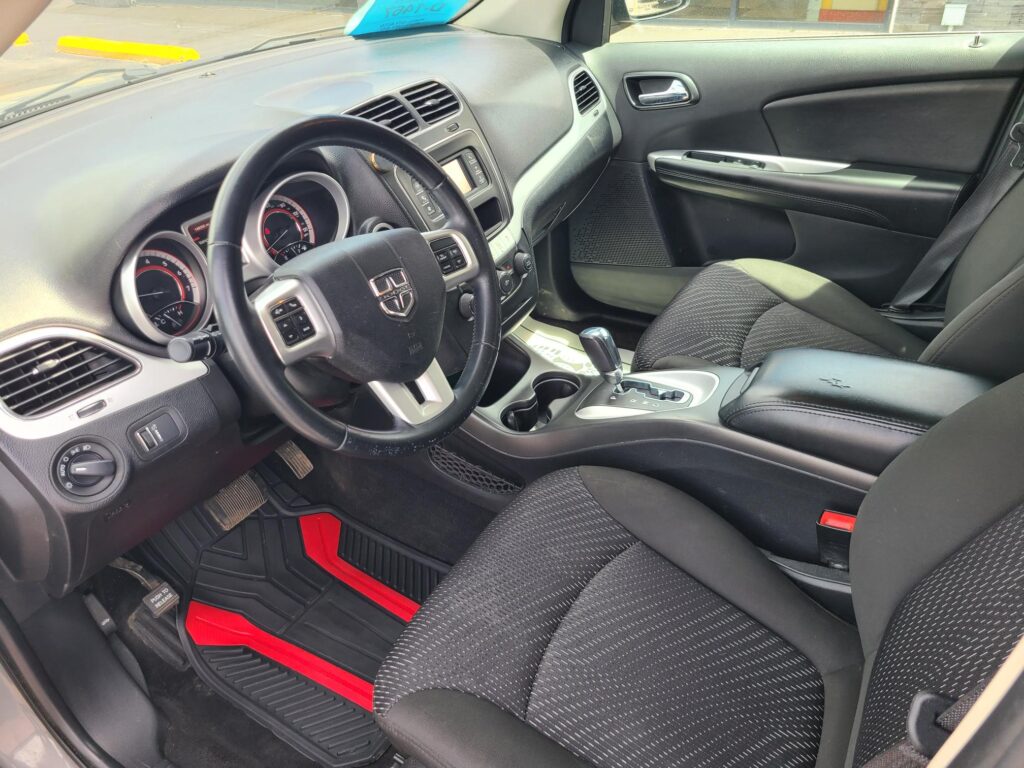 Interior of a car showcasing the steering wheel, dashboard, and center console with gear shifter