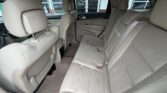Rear passenger seating in a beige SUV with three-seat row and visible headrests
