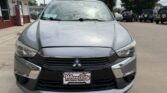 Front view of a silver Mitsubishi SUV parked in a dealership lot, with a Wheel City Auto Finance Centers license plate frame on the front bumper.