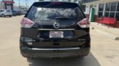 Rear view of a black Nissan Rogue SV AWD SUV in a parking lot, dealership plate reading Wheel City Auto.