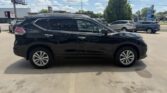 Side view of a black mid-size SUV parked in a sunny parking lot, with other cars and trees in the background.