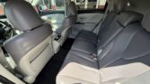 Interior of a gray leather SUV with a three-person rear bench, headrests, and rear climate vents visible.