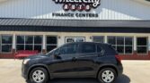 Black SUV parked in front of Wheel City Auto Finance Centers dealership on a sunny day.