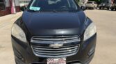 Front view of a black Chevrolet SUV parked in a dealership lot, featuring a chrome grille and Wheel City license plate frame on the bumper.
